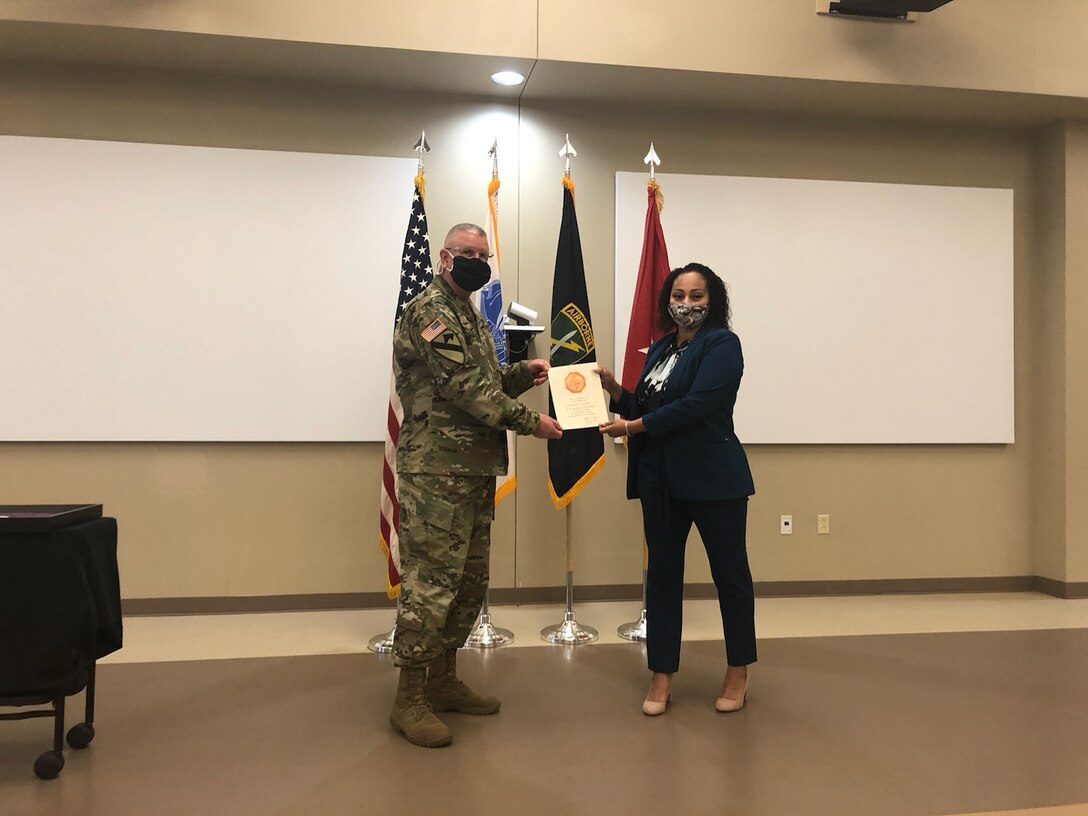 U.S. Army Civil Affairs and Psychological Operations Command (Airborne) Commanding General, Brig. Gen. Jeffrey C. Coggin, presents the Federal Length of Service Award to Kasandra Herbert for 5 years of federal service during the Soldier and Department of the Army Civilian recognition award ceremony at USACAPOC(A) Headquarters, Fort Bragg, N.C., Nov. 17, 2020. The recognition award ceremony was held to recognize 12 USACAPOC(A) Soldiers and DA civilians for Federal Length of Service Awards, Honorary Awards, Retirement recognition, and military awards.