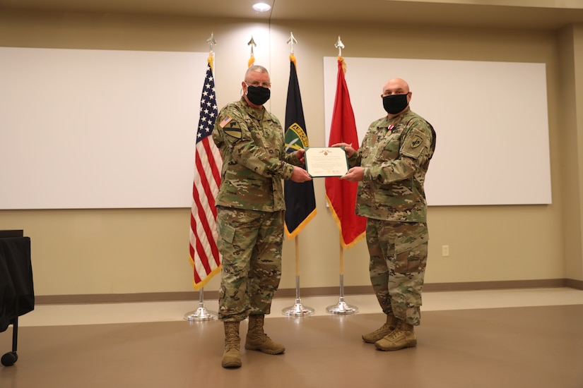 U.S. Army Civil Affairs and Psychological Operations Command (Airborne) Commanding General, Brig. Gen. Jeffrey C. Coggin, presents the Meritorious Service Medal to Master Sgt. Mark D. Garland during the Soldier and Department of the Army Civilian recognition award ceremony at USACAPOC(A) Headquarters, Fort Bragg, N.C., Nov. 17, 2020 for service as the HHC USACAPOC(A) First Sergeant. The recognition award ceremony was held to recognize 12 USACAPOC(A) Soldiers and DA civilians for Federal Length of Service Awards, Honorary Awards, Retirement recognition, and military awards.