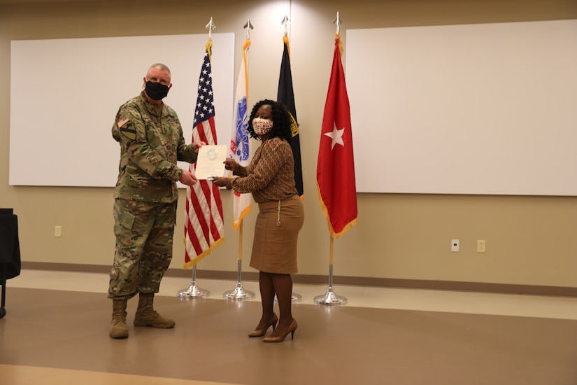 U.S. Army Civil Affairs and Psychological Operations Command (Airborne) Commanding General, Brig. Gen. Jeffrey C. Coggin, presents the Federal Length of Service Award to Shirleen E. Gandy for 25 years of federal service during the Soldier and Department of the Army Civilian recognition award ceremony at USACAPOC(A) Headquarters, Fort Bragg, N.C., Nov. 17, 2020. The recognition award ceremony was held to recognize 12 USACAPOC(A) Soldiers and DA civilians for Federal Length of Service Awards, Honorary Awards, Retirement recognition, and military awards.