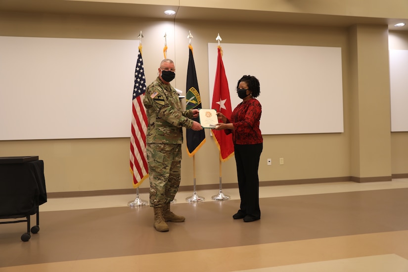 U.S. Army Civil Affairs and Psychological Operations Command (Airborne) Commanding General, Brig. Gen. Jeffrey C. Coggin, presents the Federal Length of Service Award to Angela T. Hammond for 35 years of federal service during the Soldier and Department of the Army Civilian recognition award ceremony at USACAPOC(A) Headquarters, Fort Bragg, N.C., Nov. 17, 2020. The recognition award ceremony was held to recognize 12 USACAPOC(A) Soldiers and DA civilians for Federal Length of Service Awards, Honorary Awards, Retirement recognition, and military awards.