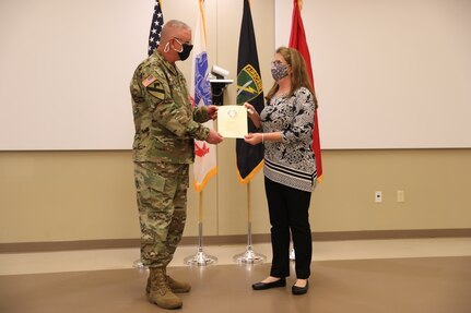U.S. Army Civil Affairs and Psychological Operations Command (Airborne) Commanding General, Brig. Gen. Jeffrey C. Coggin, presents the Federal Length of Service Award to Elizabeth J. Holman for 40 years of federal service, and recognizes her impending retirement from federal service, presenting a Department of the Army Certificate of Appreciation, during the Soldier and Department of the Army Civilian recognition award ceremony at USACAPOC(A) Headquarters, Fort Bragg, N.C., Nov. 17, 2020. The recognition award ceremony was held to recognize 12 USACAPOC(A) Soldiers and DA civilians for Federal Length of Service Awards, Honorary Awards, Retirement recognition, and military awards.