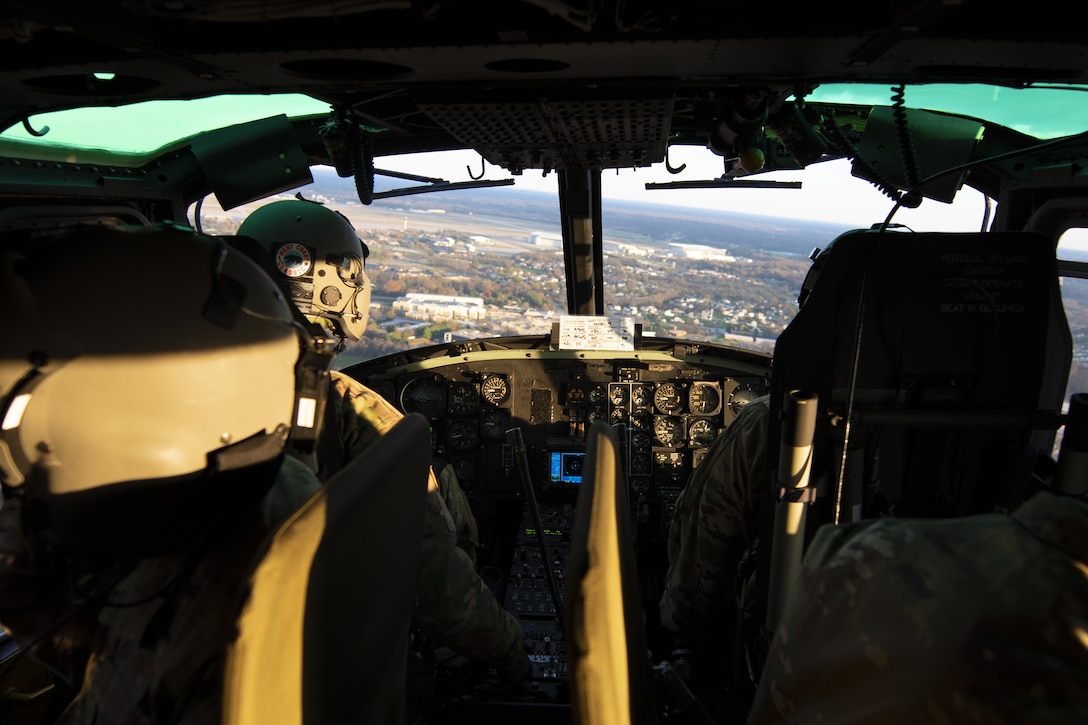 Capt. Jesse Togawa, 1st Helicopter Squadron pilot, and Staff Sgt. Drew Charles, 1st Helicopter Squadron flight engineer, give Chief Master Sgt. of the Air Force JoAnne Bass a tour of the National Capital Region in a UH-1N “Huey” at Joint Base Andrews, Md., Nov. 23, 2020. The 1st HS is one of a few units that use enlisted personnel “up front” in the aircraft assisting with flight objectives, rather than only in the cabin or cargo area. (U.S. Air Force Photo by Senior Airman Kaylea Berry)