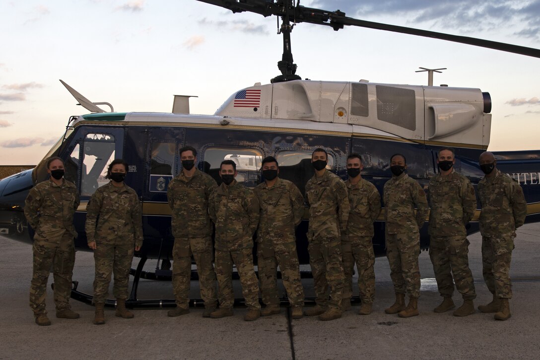 The 316th Operations Group pose for a group photo with Chief Master Sgt. of the Air Force JoAnne Bass in front of a UH-1N “Huey” at Joint Base Andrews, Md., Nov. 23, 2020. The UH-1N “Huey” will eventually be phased out by the H-139A Grey Wolf. (U.S. Air Force Photo by Senior Airman Kaylea Berry)
