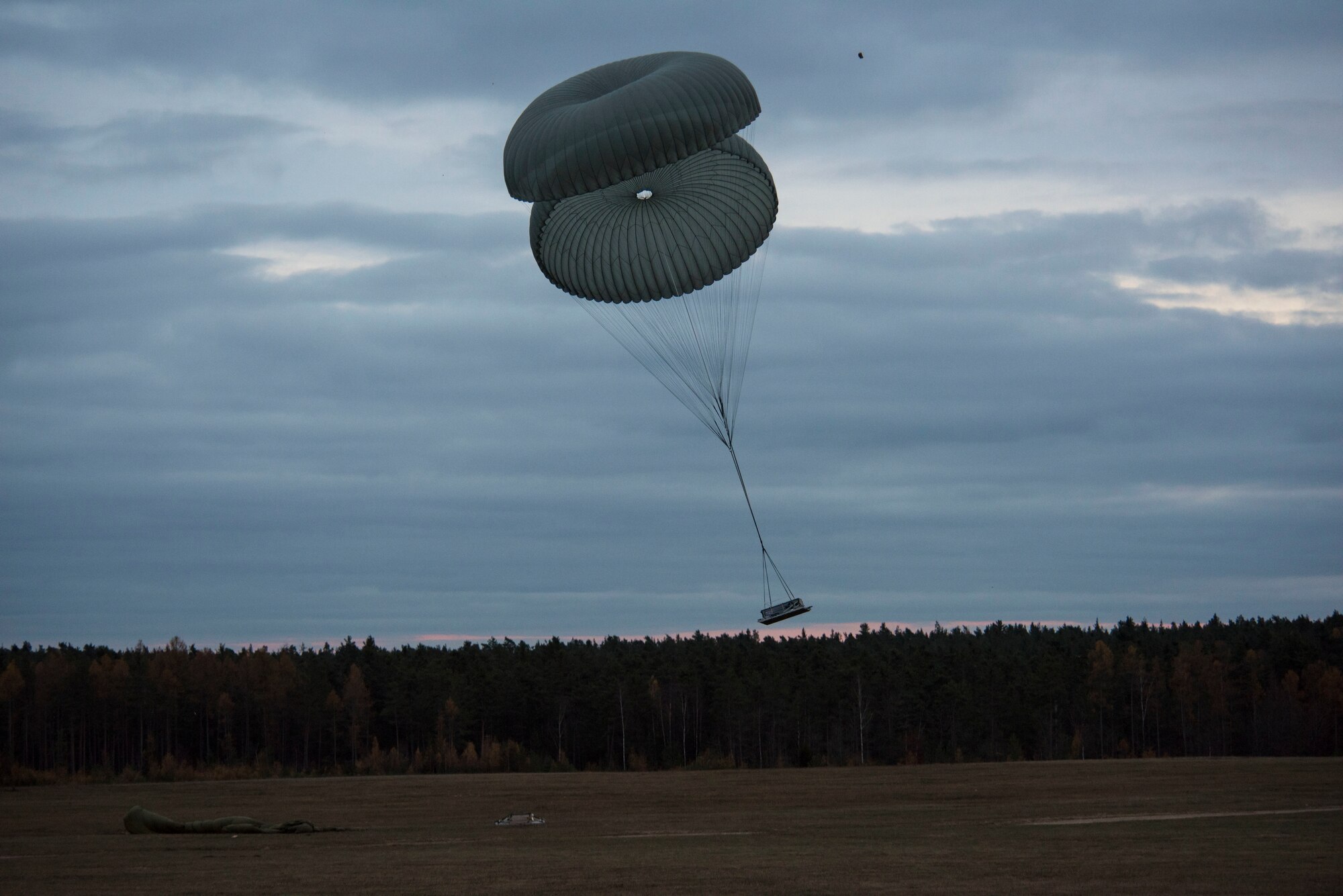 Heavy cargo descends into a dropzone during exercise Agile Wolf 21-01.