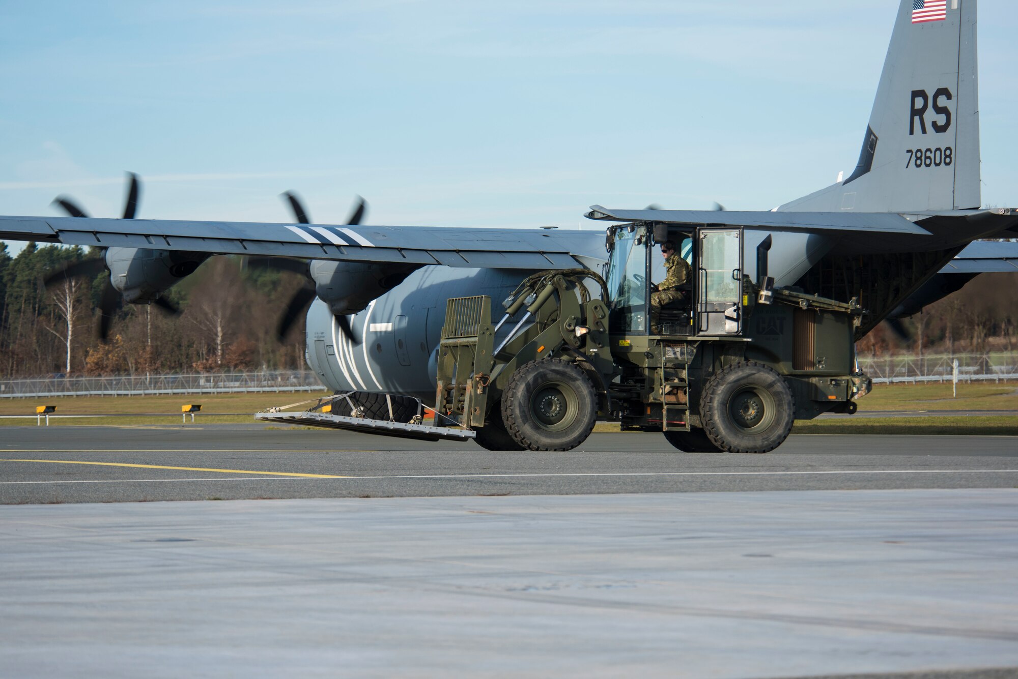 A U.S. Air Force Airman assigned to the 435th Contingency Response Group retrieves cargo from a C-130J Super Hercules aircraft during exercise Agile Wolf 21-01.