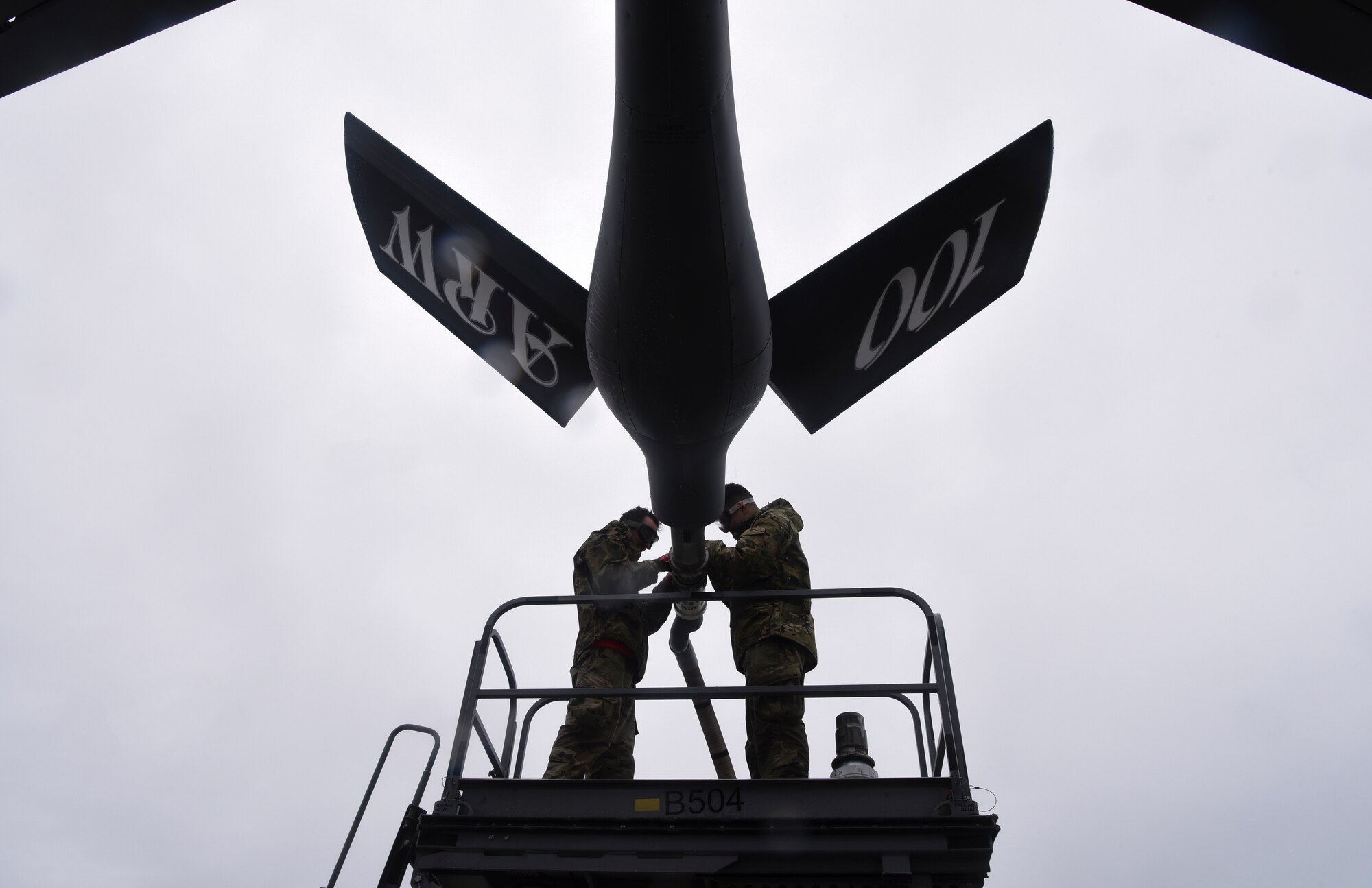 U.S. Air Force Staff Sgt. Elijah Ward, left, 100th Aircraft Maintenance Squadron crew chief, and Airman 1st Class Julian Nailing, right, 100th AMXS crew chief, detach the drogue from the boom of a KC-135 Stratotanker aircraft at Royal Air Force Mildenhall, England, Oct. 29, 2020. For more than 60 years, these aircraft have been key to the global reach of the U.S. Air Forces in Europe and Air Forces Africa.  (U.S. Air Force photo by Airman 1st Class David Busby)