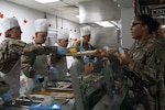 A solder is served Thanksgiving dinner.