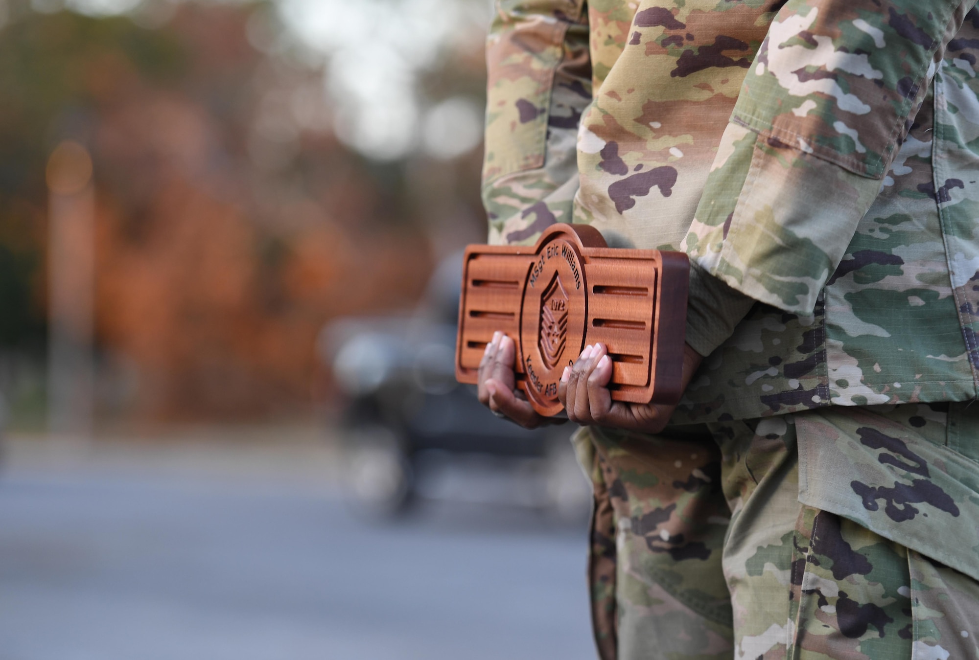 U.S. Air Force Master Sgt. Eric Williams, 81st Training Support Squadron section chief, holds a plaque during the Keesler Senior Noncommissioned Officer Induction Ceremony outside Mathies Hall at Keesler Air Force Base, Mississippi, Nov. 19, 2020. Over 20 Airmen were recognized during the ceremony, which also included a drive-thru congratulatory parade by Keesler personnel. (U.S. Air Force photo by Kemberly Groue)