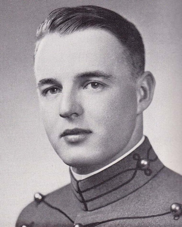 A man in a military uniform poses for a photo.
