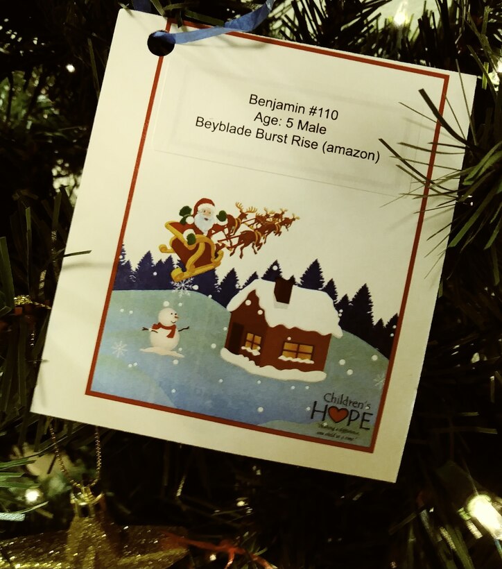 Children's Hope Foster Family Agency tag hanging from the Angel Tree as on of many waiting for someone to pick it from the branch and fulfill a child's wish. (U.S. photo by Rossi D. Pedroza-Bertrand)