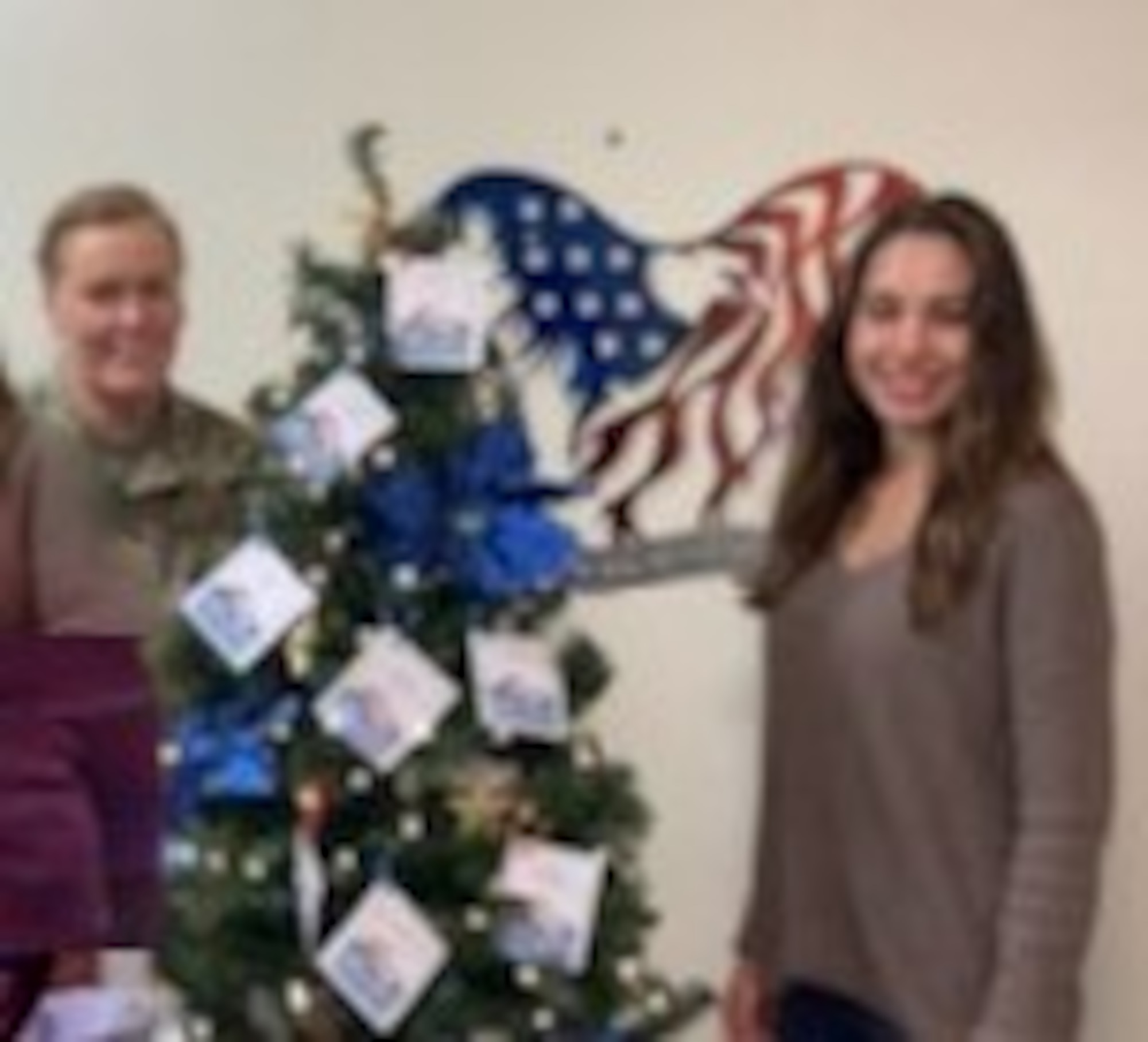 Master Sgt. Eileen Safford and Ms. Natalie Fiore standing next to the Angel Tree they purchased and set up for the members of the 940th Air Refueling Wing, so they could give to a foster child during the holiday. U.S. photo courtesy of 940 MXG staff)