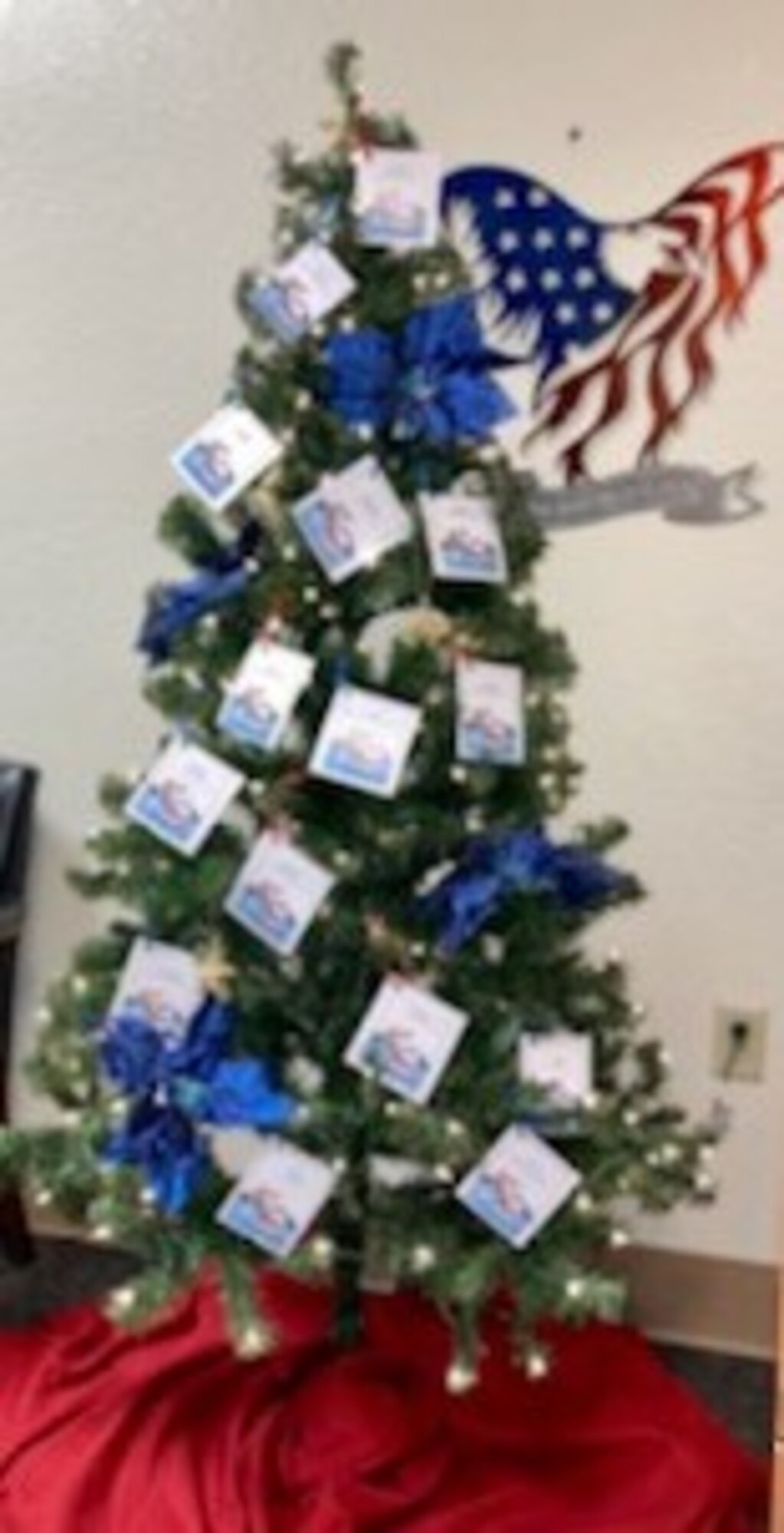 Angel Tree standing tall and bright with colorful tags on the branches representing foster children sharing their personal wish list for this holiday season. (U.S. photo by Rossi D. Pedroza-Bertrand)
