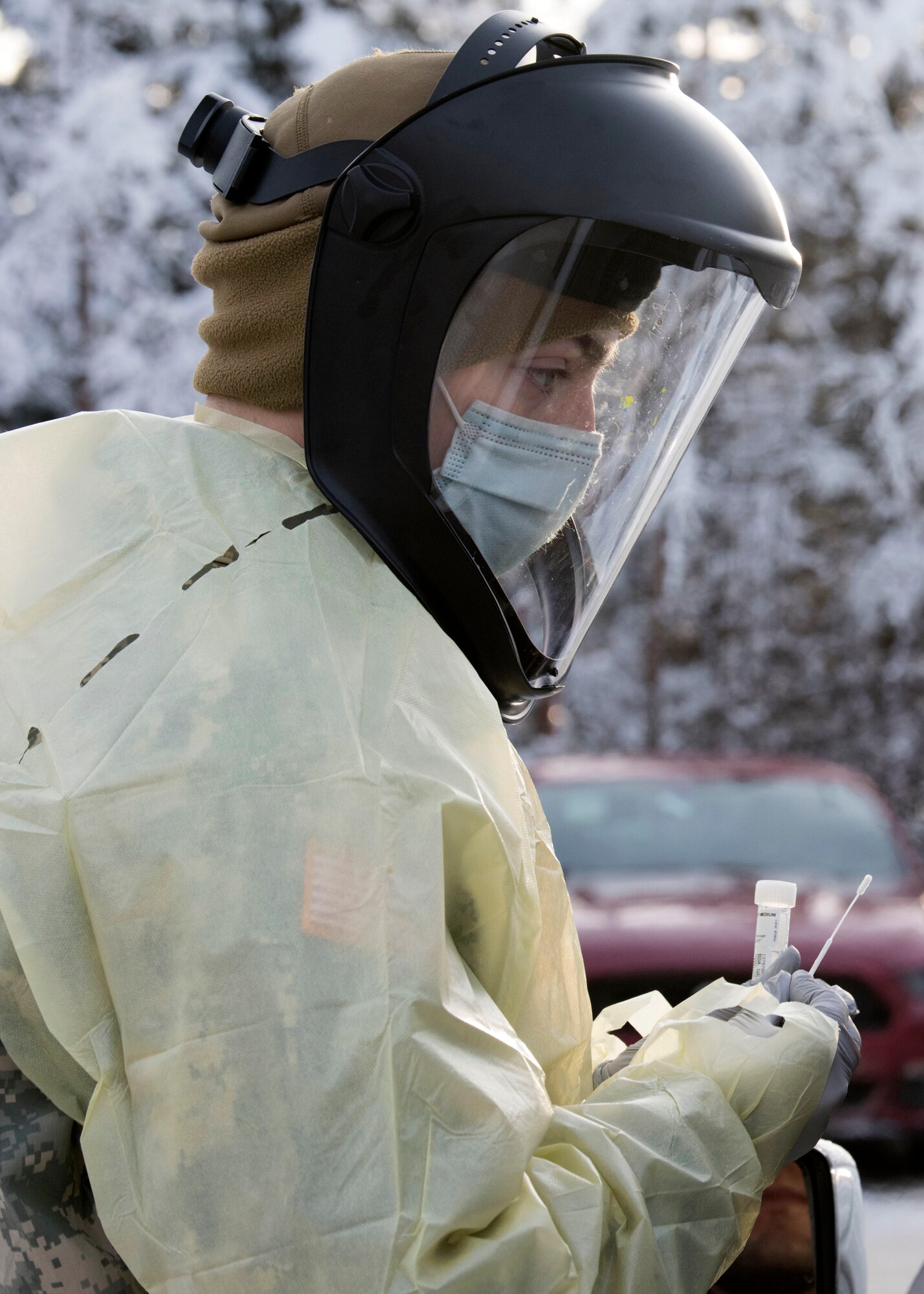 U.S. Army Pvt. Daniel Murtagh, a combat medic specialist assigned to the 1st Squadron, 40th Cavalry Regiment (Airborne), 4th Infantry Brigade Combat Team (Airborne), 25th Infantry Division, U.S. Army Alaska, prepares to test a patient for COVID-19 at Joint Base Elmendorf-Richardson, Alaska, Nov. 20, 2020. The 673d MDG stood-up a drive-thru testing clinic to offer a fast, safe way to provide testing to base personnel and their dependents.