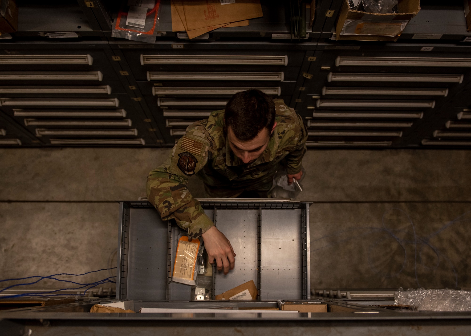 Airman 1st Class Ryan Kekic, 4th Logistics Readiness Squadron warehouse maintainer, grabs a part for an F-15E Strike Eagle engine at the aircraft parts store on Seymour Johnson Air Force Base, North Carolina, Nov. 6, 2020.