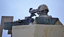 A 3-71 CAV, 10 MTN DIV Soldier takes aim with an M2 .50 caliber machine gun outfitted with the FWS-CS during testing at Fort Drum, NY