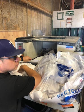 Member shreds paper at the 97th Air Mobility Wing Recycling Center.
