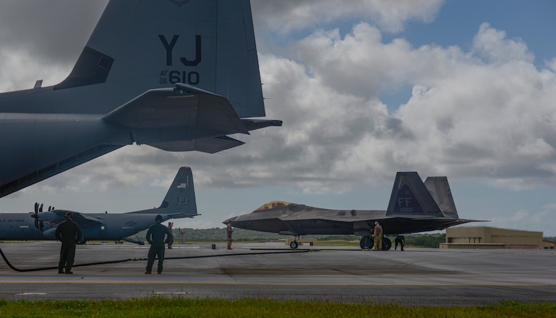 An F-22 Raptor assigned to the 94th Expeditionary Fighter Squadron completes a hot refuel from a fuel bladder carried by a C-130J Hercules assigned to the 36th Airlift Squadron, Yokota Air Base, Japan, during a Dynamic Force Employment at Andersen Air Force Base, Guam, Nov. 22, 2020. DFE is an operational platform that allows our forces to be strategically predictable and operationally unpredictable. The U.S. Air Force is postured and ready to respond to crises and contingencies throughout the U.S. Indo-Pacific Command, contributing to regional stability and a free and open Indo-Pacific. (U.S. Air Force photo by Senior Airman Michael S. Murphy)