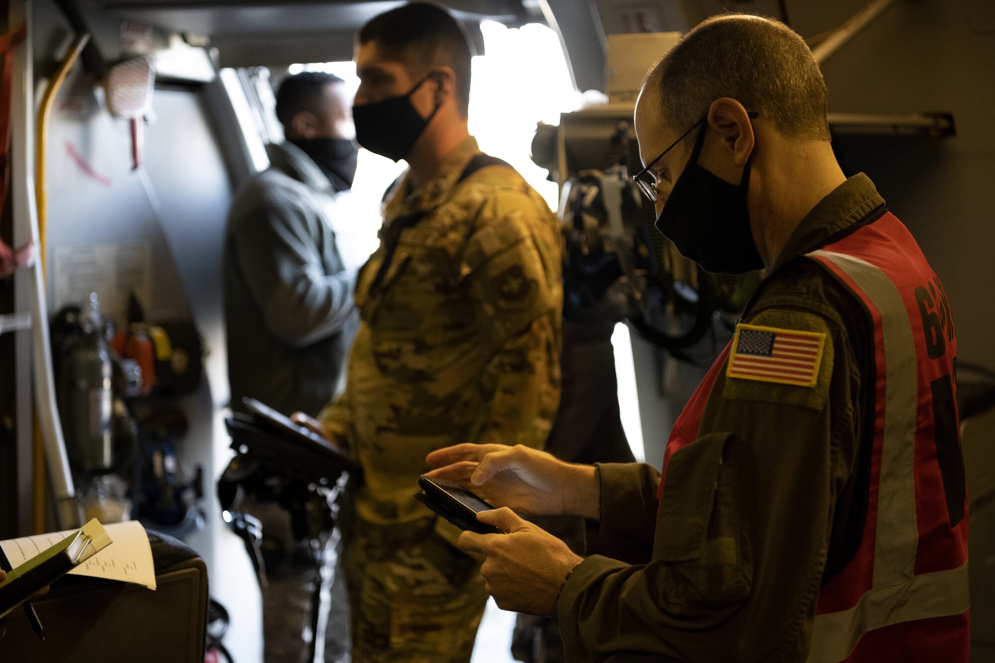 U.S. Air Force Lt. Col. Michael McCartney, 6th Air Refueling Squadron KC-10 Extender instructor pilot, reads operating instructions for Aircrew Eye and Respiratory System gear Nov. 16, 2020, at Travis Air Force Base, California. McCartney was one of three 60th Air Mobility Wing Inspection Team members on a simulated aerial refueling flight who evaluated the aircrew’s performance during a basewide exercise. (U.S. Air Force photo by Airman 1st Class Alexander Merchak)