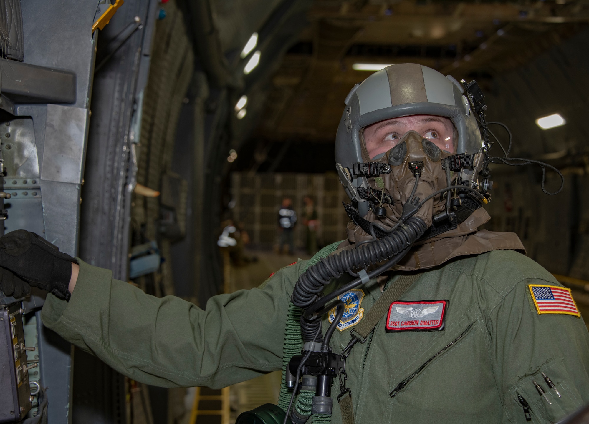 U.S. Air Force Staff Sgt. Cameron Dimatteo, 22nd Airlift Squadron loadmaster, performs a preflight safety check aboard a C-5M Super Galaxy during an exercise Nov. 18, 2020, at Travis Air Force Base, California. Airmen at Travis AFB participate in readiness exercises to ensure they can operate in contested environments. (U.S. Air Force photo by Heide Couch)
