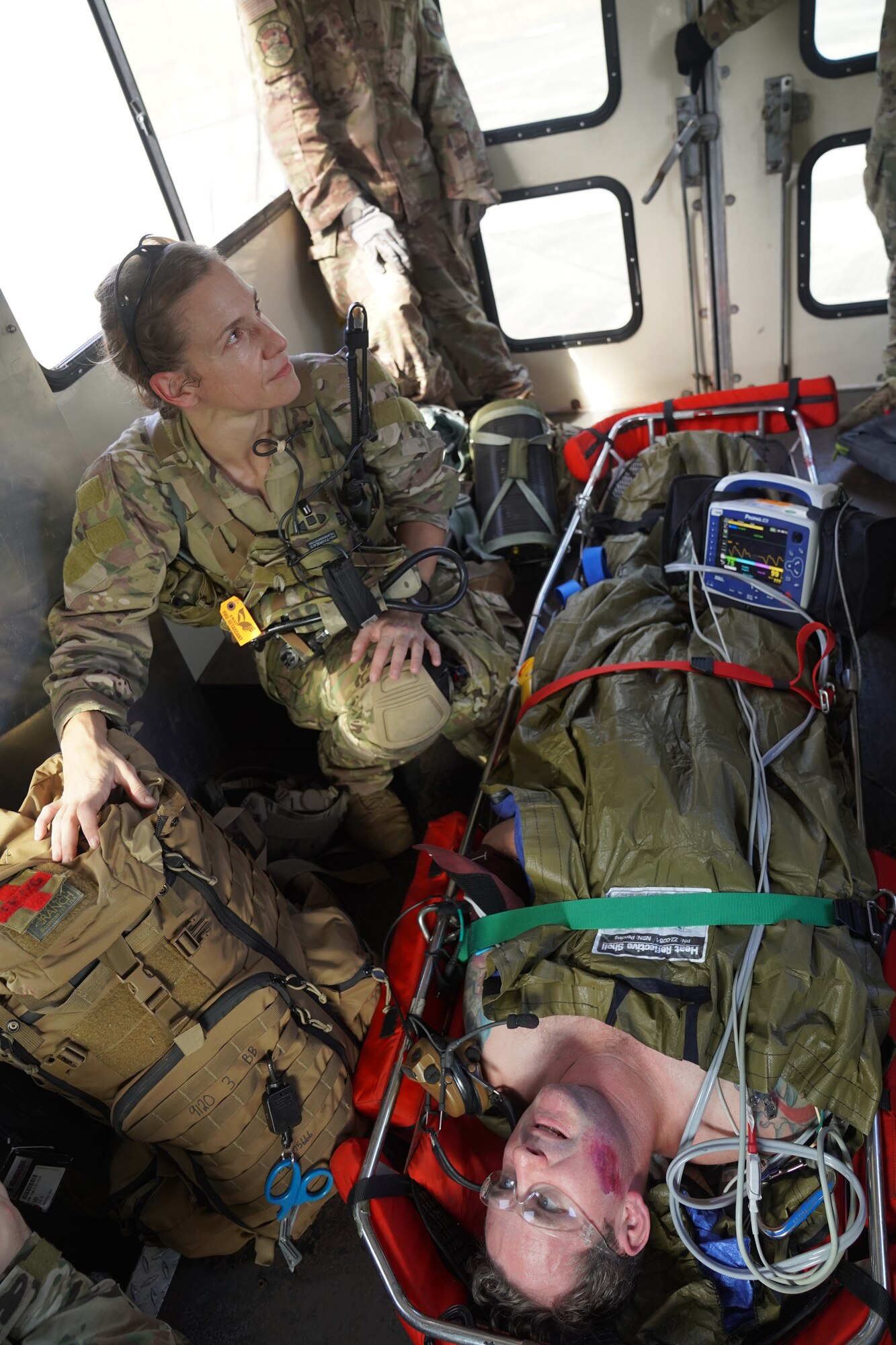 Major Shana Hirchert, 353rd Special Operations Support Squadron flight surgeon, escorts Tech. Sgt. Andrew Bowers, 353 SOSS medical training non-commissioned officer in charge and scenario role-player, ensuring medical care on Kadena Air Base, Japan, after an open water search and rescue training, Nov. 19, 2020.