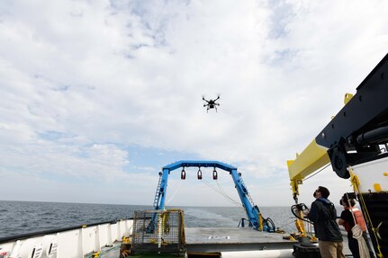 Alan Jaeger, Naval Surface Warfare Center, Port Hueneme Division’s Office Of Technology (00T) research and technology manager, and Ian Wilson, 00T’s cybersecurity researcher, test out the capabilities of a quadcopter drone at the stern of a ship on Friday, Sept. 18.