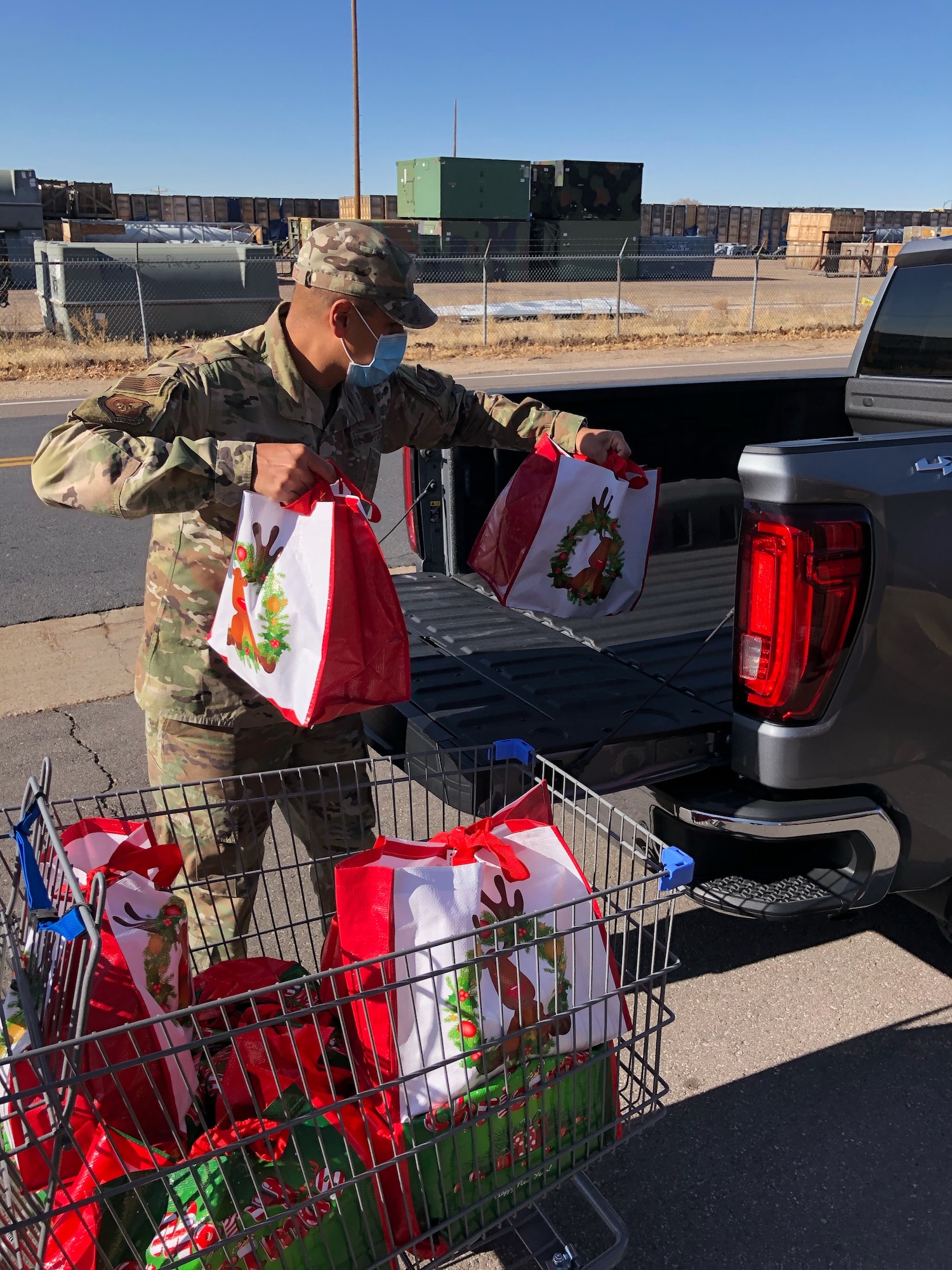 Senior Master Sgt. Jason Delacruz, 75th Medical Group first sergeant, loads bags filled with Thanksgiving food items into the bed of a truck Nov. 20, 2020, at Hill Air Force Base, Utah. Operation Warm Heart, a first sergeant’s program, teamed with the commissary to deliver bags filled with turkeys, hams and other goods to assist Airmen and their families with the upcoming holiday. (Courtesy photo)