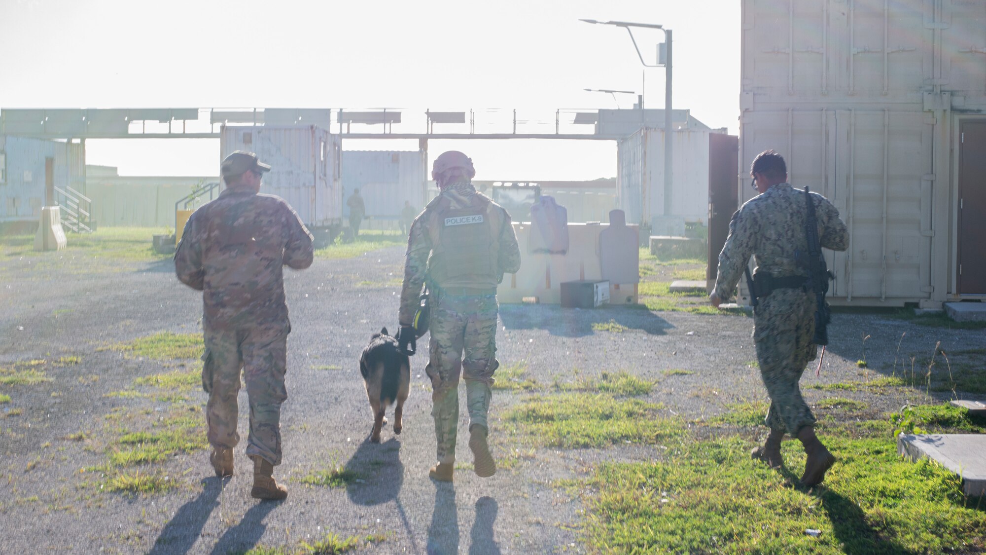 Sailors, Marines, and Airmen finish up an urban training exercise on Andersen Air Force Base, Guam Nov. 20. The service members exchanged MWD techiques to enhance joint mission effectivness. (U.S. Air Force photo by Staff Sgt. Nicholas Crisp)