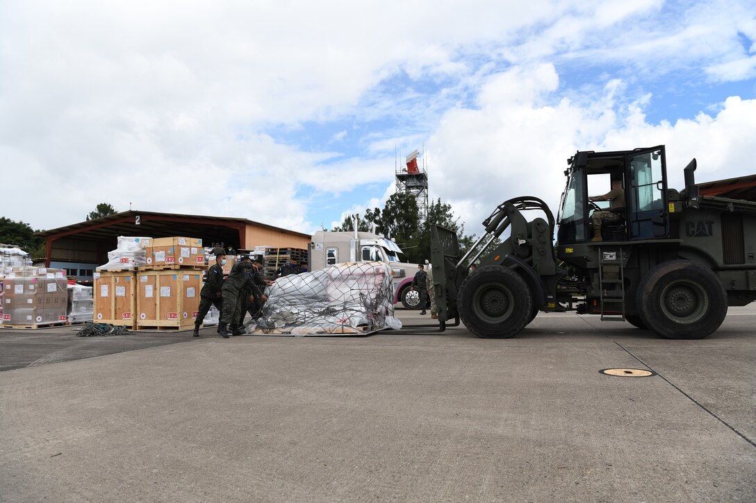 U.S. Air Force Airmen and Members of the Honduran air force unload pallets of humanitarian assistance sent by the Canadian Red Cross to Honduras in response to hurricane Iota at Soto Cano Air Base in Honduras, Nov. 22, 2020.