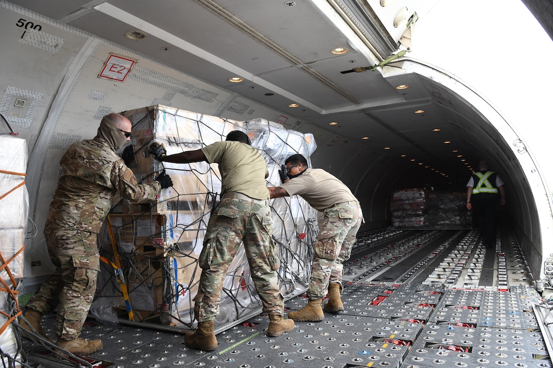 U.S. Air Force Airmen unload pallets of humanitarian assistance sent by the Canadian Red Cross to Honduras in response to hurricane Iota at Soto Cano Air Base in Honduras, Nov. 22, 2020.