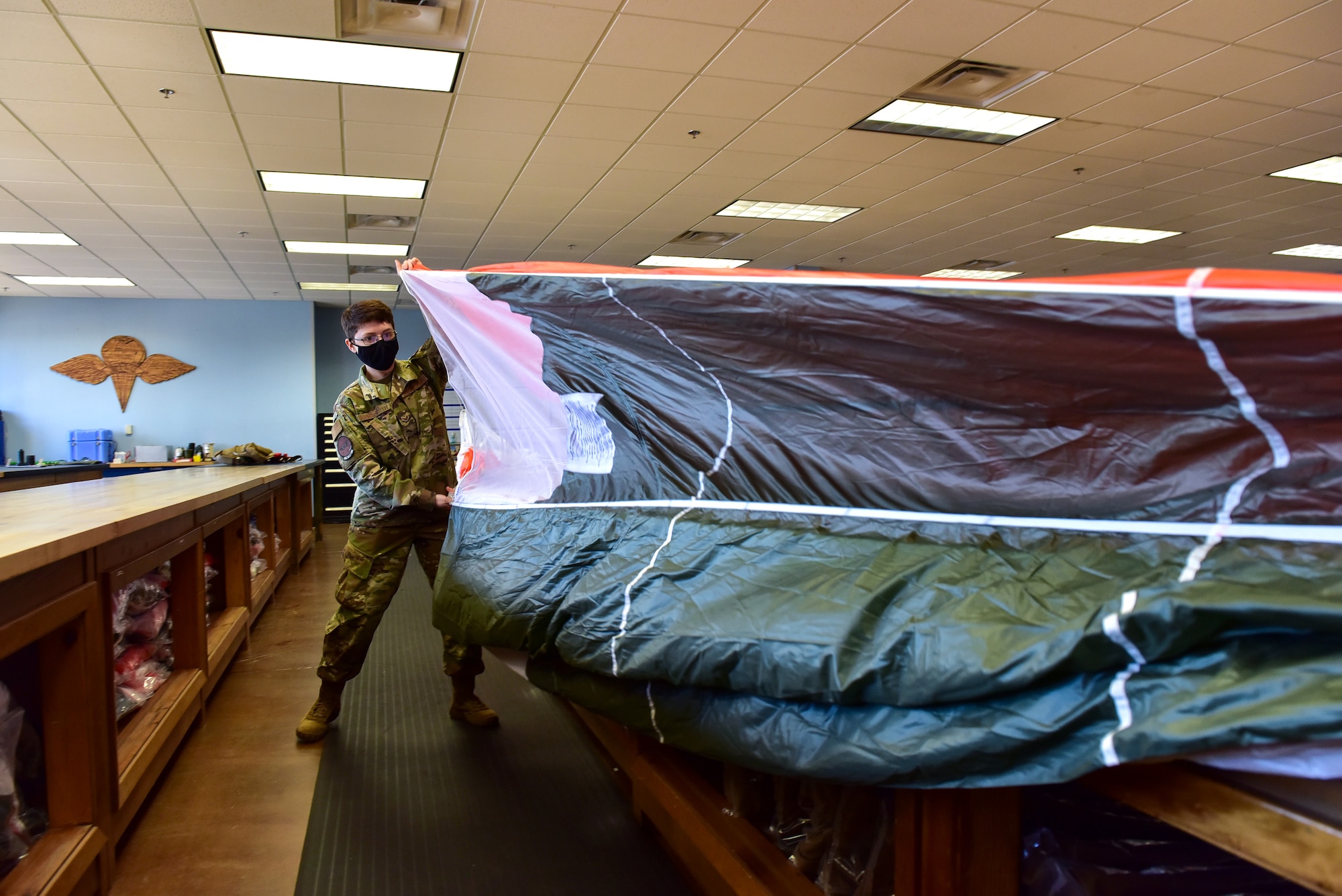 a woman holds a parachute