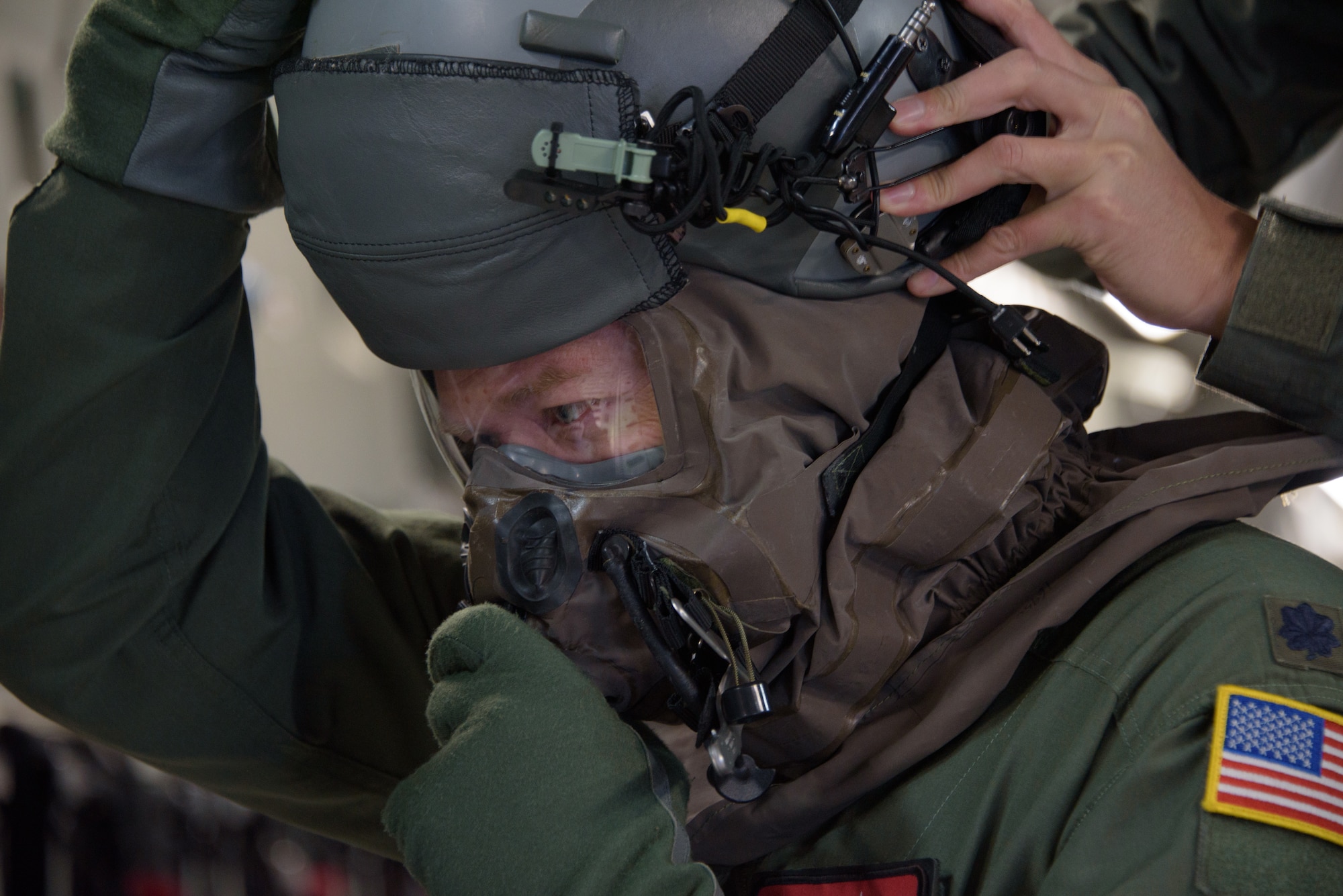 U.S. Air Force Lt. Col. Michael Pettibone, 21st Airlift Squadron C-17 Globemaster III pilot, dons Aircrew Eye and Respiratory Protection System (AERPS) equipment as part of a base exercise Nov. 16, 2020, at Travis Air Force Base, California. Airmen at Travis AFB participate in readiness exercises to ensure they can operate in contested environments.. (U.S. Air Force photo by Tech. Sgt. Traci Keller)