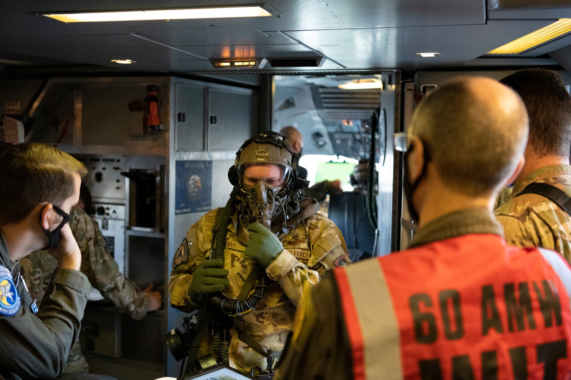 U.S. Air Force Capt. Jay Denny, 6th Air Refueling Squadron KC-10 Extender pilot, dons Aircrew Eye and Respiratory System (AERPS) equipment Nov. 16, 2020, at Travis Air Force Base, California. Denny participated in a basewide exercise to test his use of the AERPS gear. (U.S. Air Force photo by Airman 1st Class Alexander Merchak)