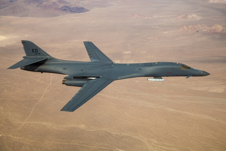 A B-1B Lancer with a Joint Air-to-Surface Standoff Missile (JASSM) flies in the skies above Edwards Air Force Base, California, Nov. 20. The flight was a demonstration of the B-1B's external weapons carriage capabilities. (Air Force photo by Ethan Wagner)