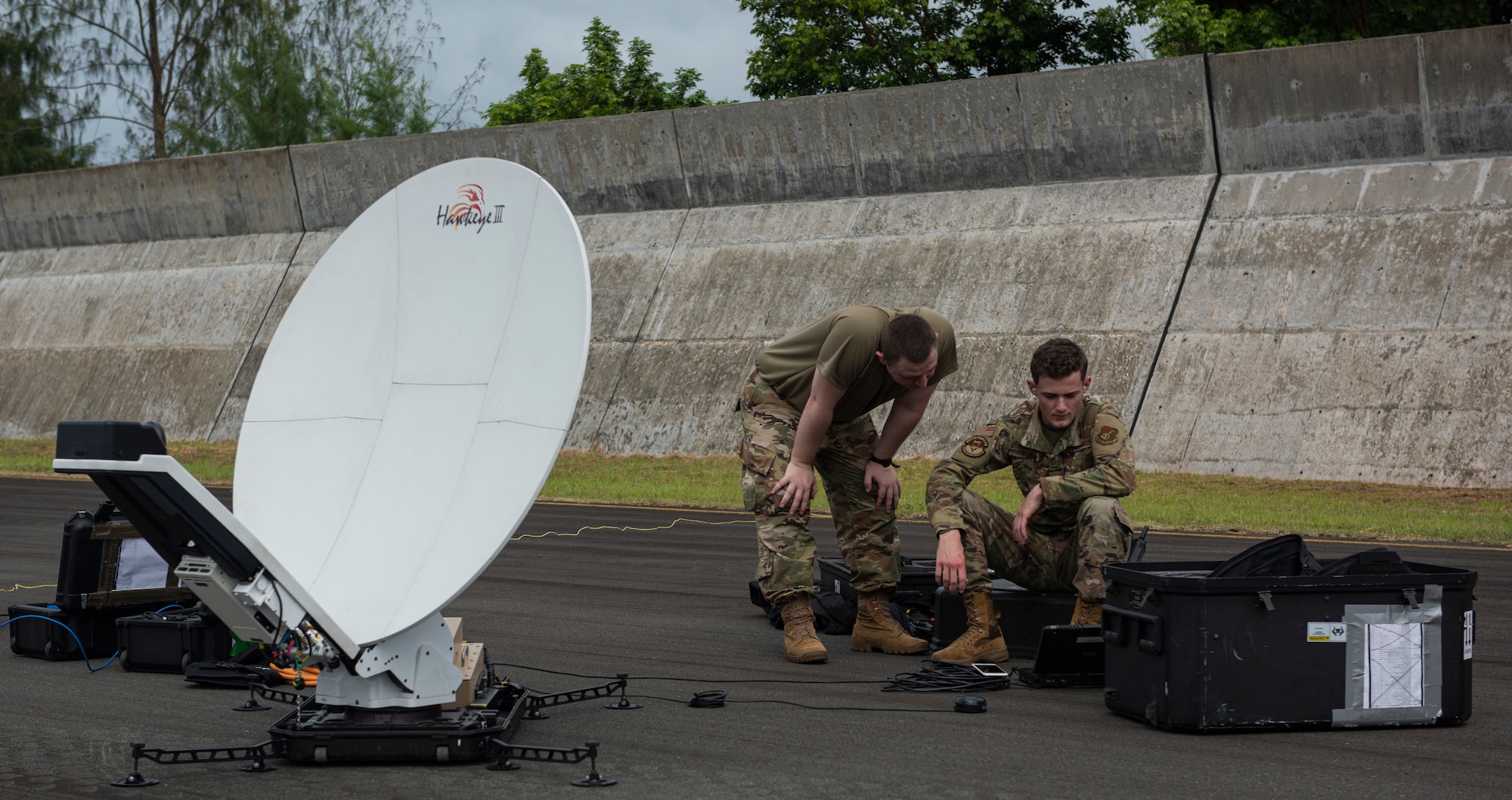 U.S. Air Force Staff Sgt. Daniel Steuer (left), a system supervisor assigned to the 374th Communications Squadron, Yokota Air Base, Japan, and USAF Airman 1st Class Kinsley Noel, a 374th CS radio frequency technician, set up a Hawkeye satellite at Babelthuap, Palau, during a Dynamic Force Employment, Nov. 23, 2020. DFE is an operational platform that allows our forces to be strategically predictable and operationally unpredictable. The U.S.’ steadfast commitment to the security and stability of the Indo-Pacific region remains unchanged. (U.S. Air Force photo by Senior Airman Michael S. Murphy)