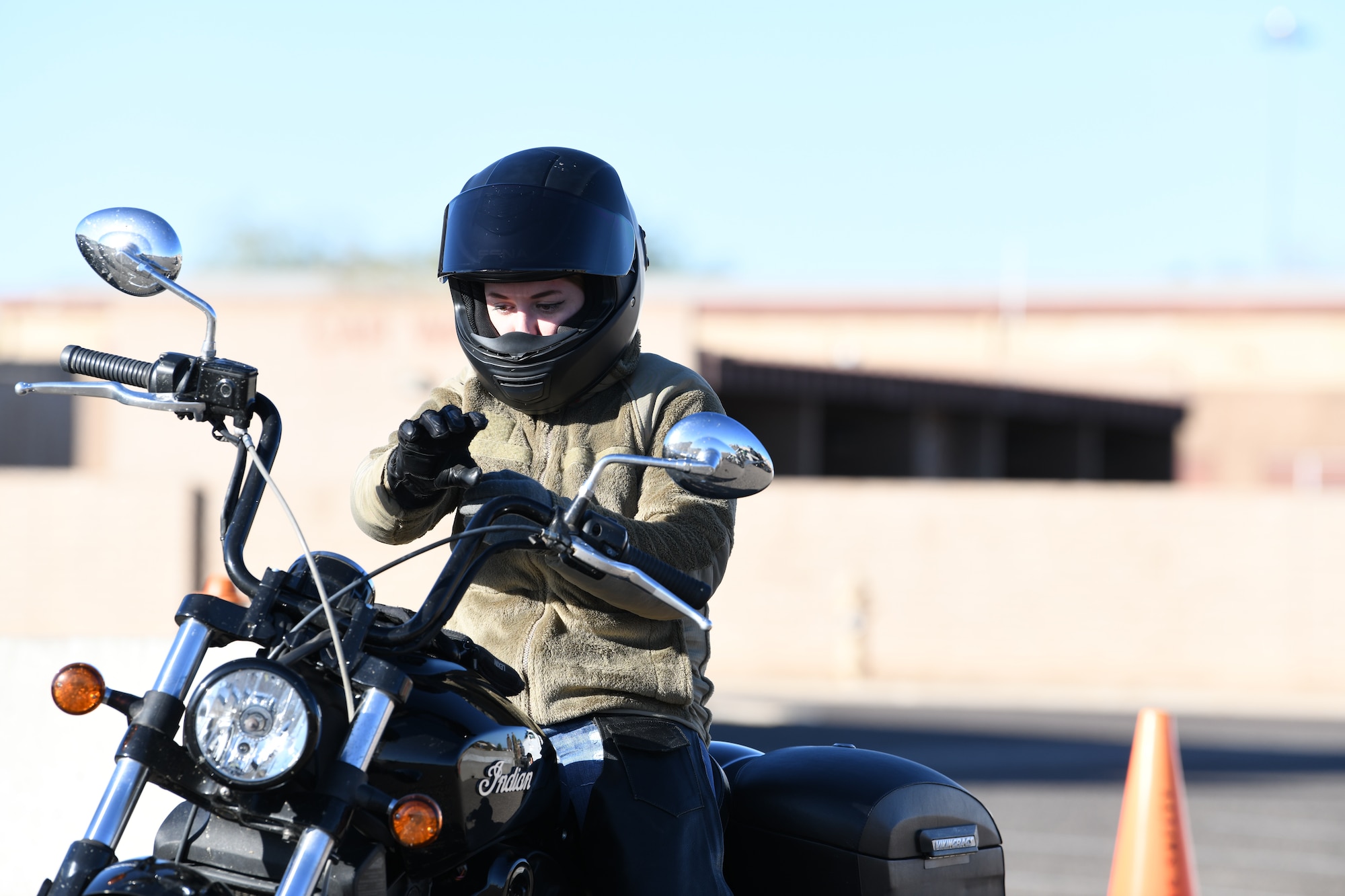 Staff Sgt. Josie Cornella, member of the 944th Maintenance Squadron, adjusts her gloves as she waits to depart on a motorcycle safety program mentorship ride Nov. 8 at Luke Air Force Base, Ariz. The program provides members with their required motorcycle safety training certification.