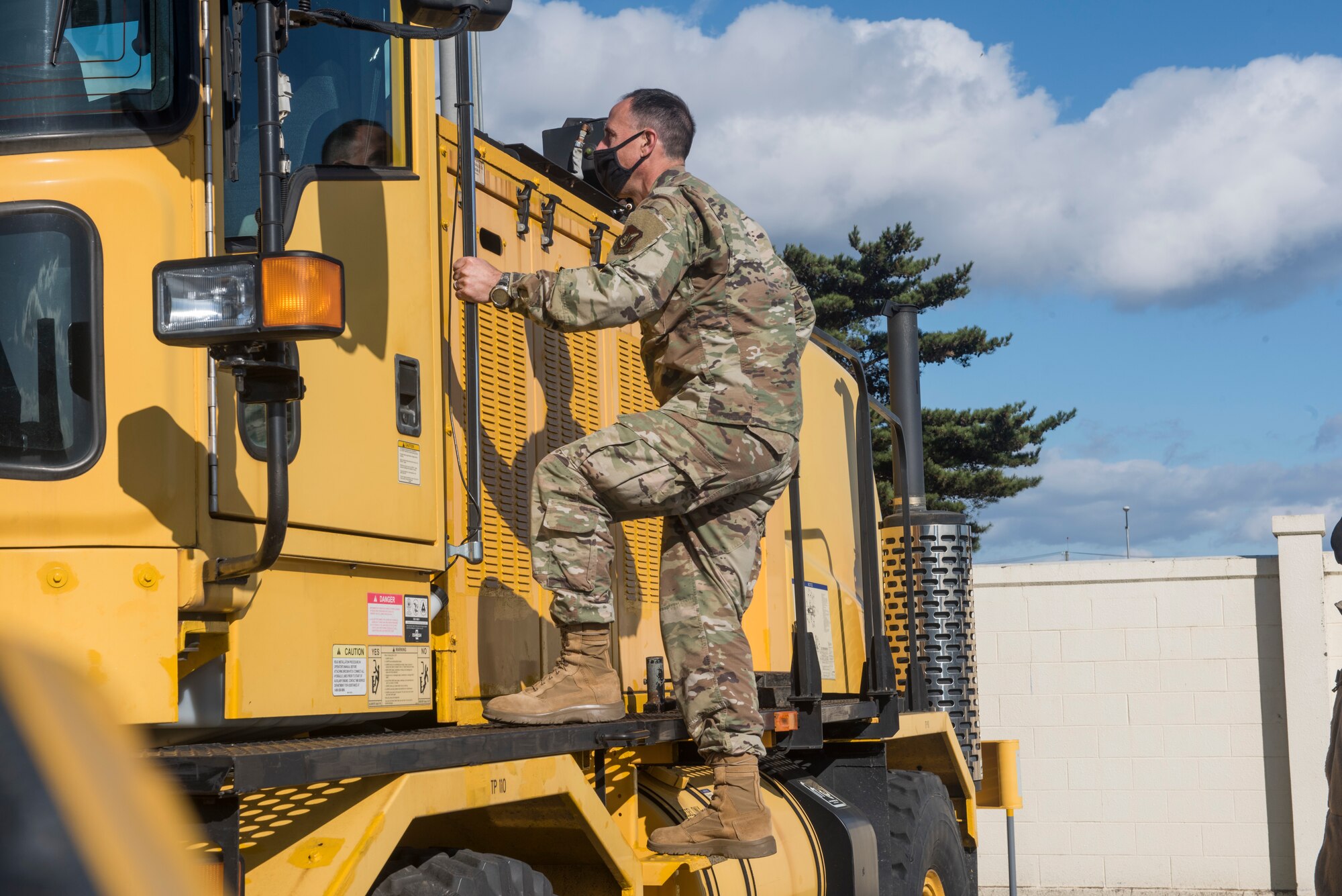 U.S. Air Force Brig. Gen. Leonard J. Kosinski, the 5th Air Force vice commander, enters a snow plow during the "Snow Rodeo" at Misawa Air Base, Japan, Nov. 24, 2020. The Snow Rodeo allows Airmen to participate in a friendly competition in snow clearing operations. Misawa has a strong lead on keeping the title of the snowiest air force base in the world. This keeps civil engineers busy with 24-hour operations during the snow season, ensuring the airfield is open regardless of weather conditions. (U.S. Air Force photo by Airman 1st Class Leon Redfern)