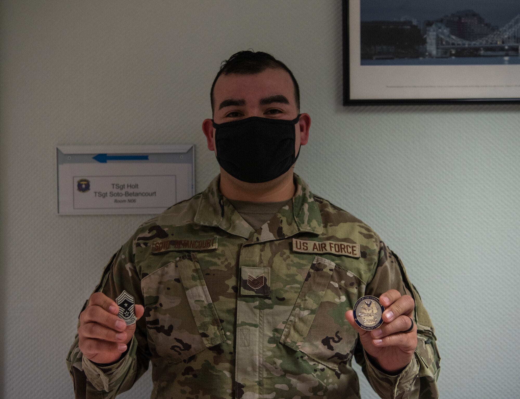U.S. Air Force Tech. Sgt. Cesar Soto-Betancourt, 86th Dental Squadron general dentistry noncommissioned officer in charge, holds two challenge coins at Ramstein Air Base, Germany, Nov. 19, 2020.