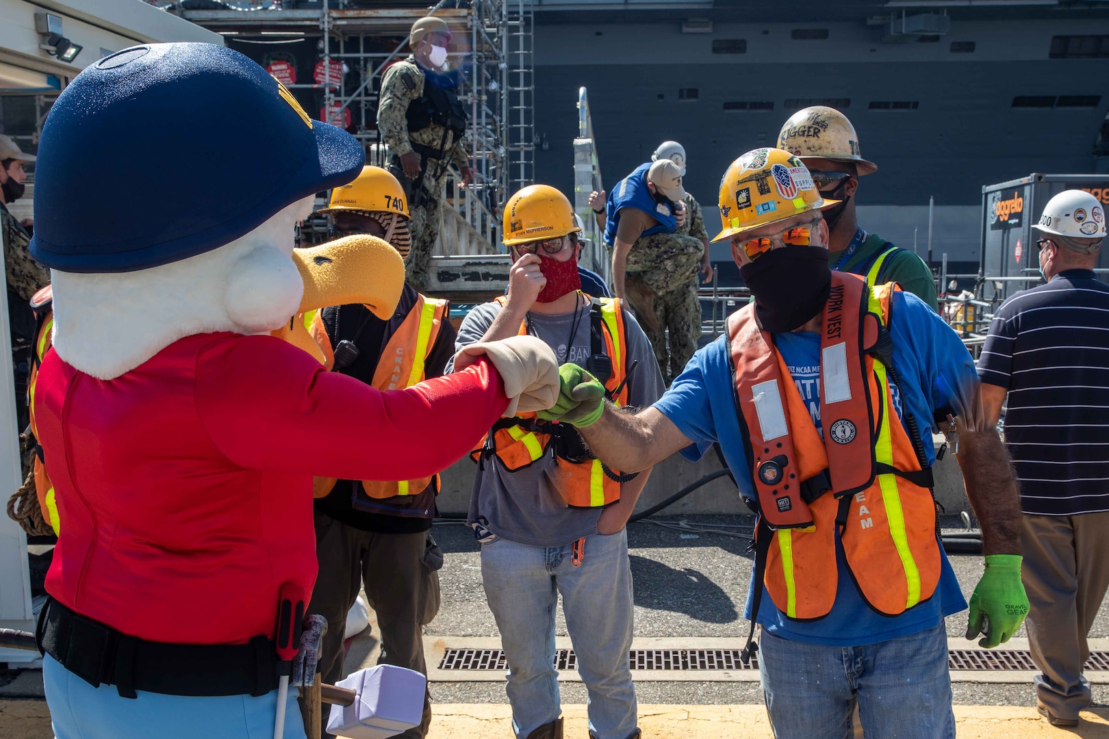 Yardbird Sam bumps knuckles with NNSY employees during the arrival of the USS Pasadena (SSN 752) arrival.