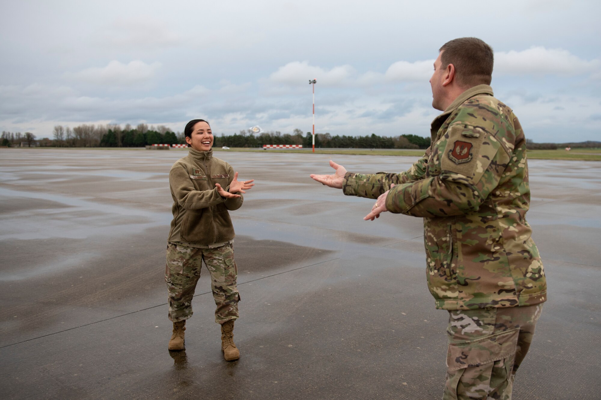 U.S. Air Force Col. Kurt Wendt, right, 501st Combat Support Wing commander, tosses a coin of recognition to Capt. Jody Hasebe, left, 420th Air Base Squadron operations and installation reception officer, for organizing the visit at Royal Air Force Fairford, England, Nov. 18. 2020. Allied Land Command (LANDCOM) conducted a combat readiness evaluation on the NATO Headquarters Allied Rapid Reaction Corp (ARRC) during LOLE20, which took place at RAF Fairford and South Cerney, England, Nov. 9-19, 2020. This was a complex multi-domain exercise designed to test the war-fighting capabilities of the ARRC in a COVID-19 environment including combat operations. LOLE20 was a key NATO exercise to validate and certify the Gloucester-based ARRC as a NATO war-fighting corps at full operational readiness, capable of commanding up to 120,000 multinational troops across a full spectrum of military operations. (U.S. Air Force photo by Senior Airman Jennifer Zima)