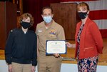 Cmdr. Timothy A. Platz, a staff surgical oncologist at Naval Medical Center Portsmouth (NMCP), receives Annual Faculty Teaching Award from the Uniformed Services University of Health Sciences at an award ceremony in the NMCP auditorium on Nov. 4.