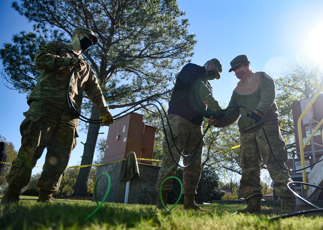 Airmen working on electrical cables
