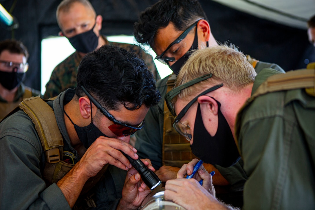 Explosive ordnance disposal technicians dismantle a TOW 2F anti tank missile as part of an “ordnance exploitation proof of concept range” at Camp Schwab, Japan, Nov. 18.