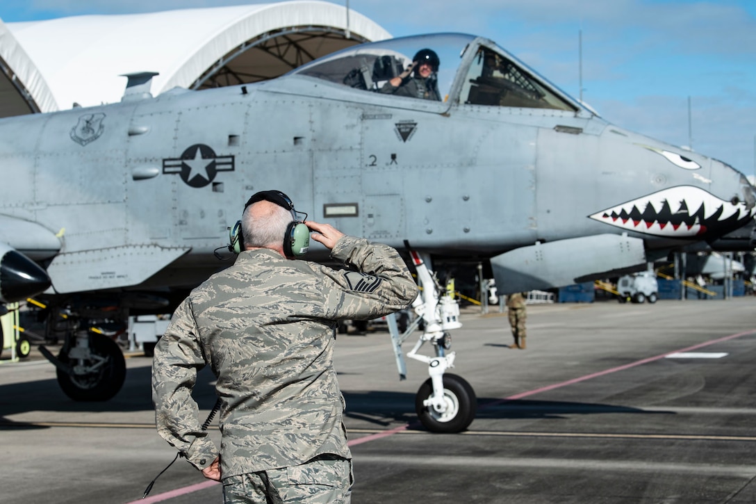 Retired crew chief salutes pilot.