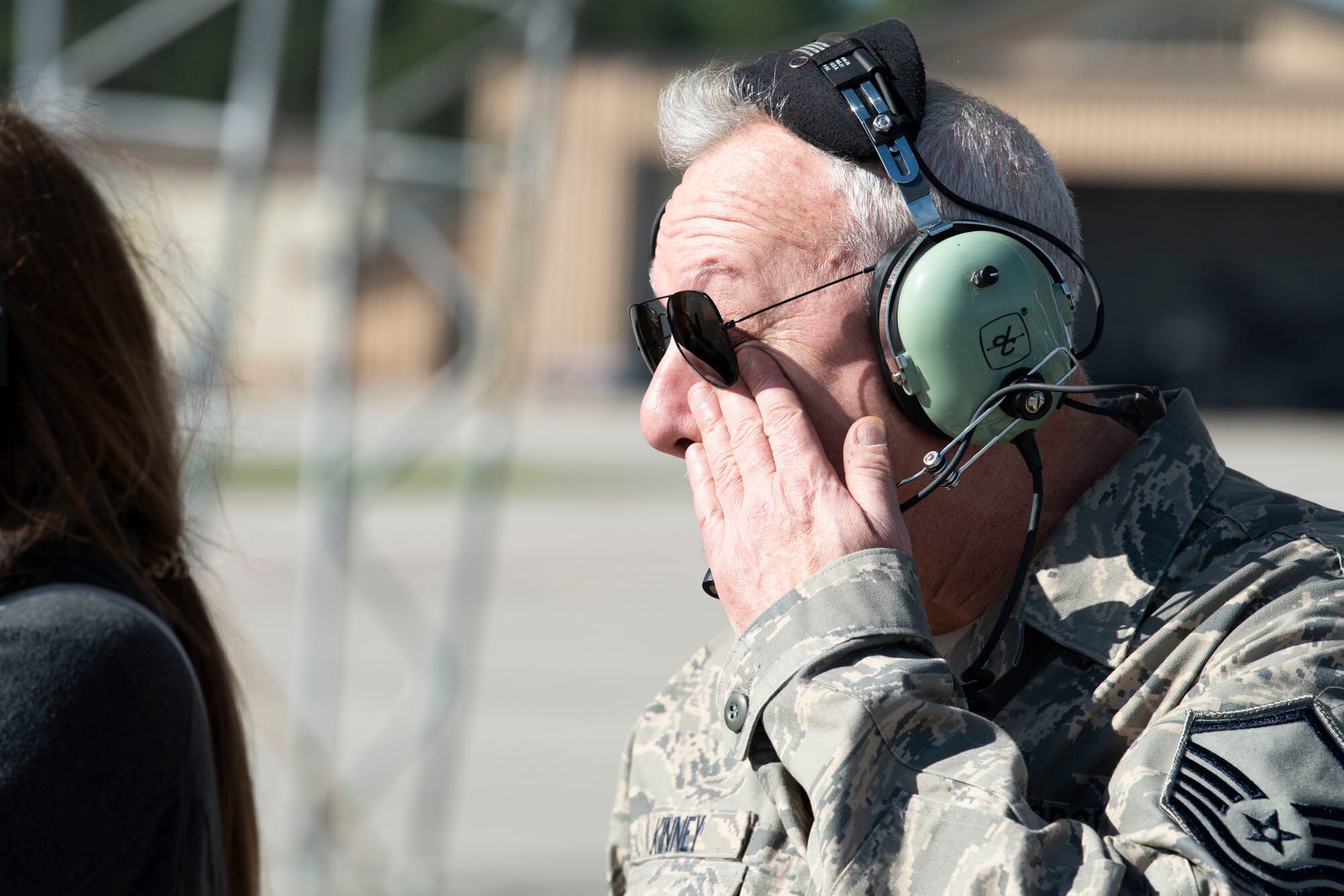 Retired crew chief wipes tear from his face.