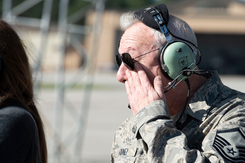 Retired crew chief wipes tear from his face.