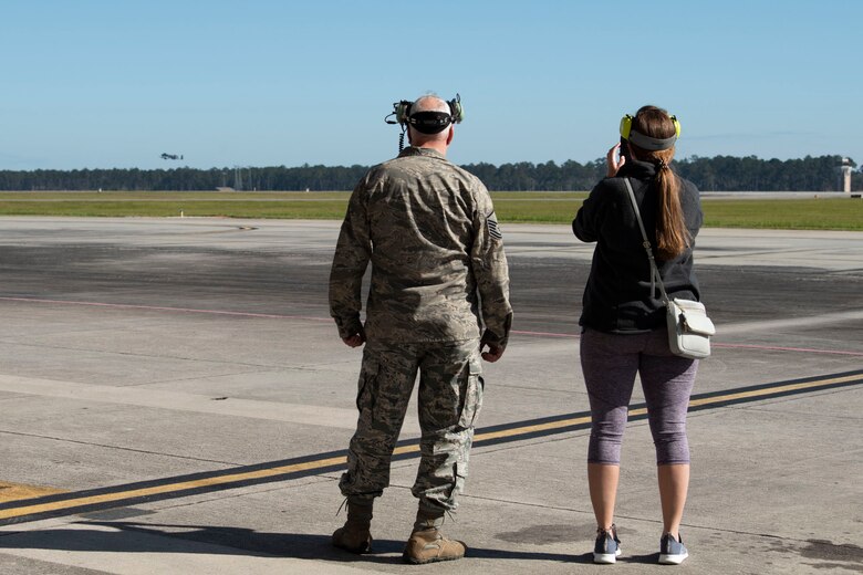 Family watches pilot take off.