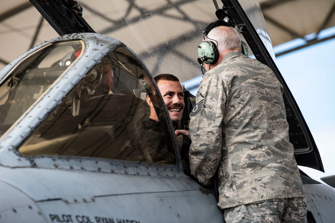 Retired crew chief shakes pilot's hand.