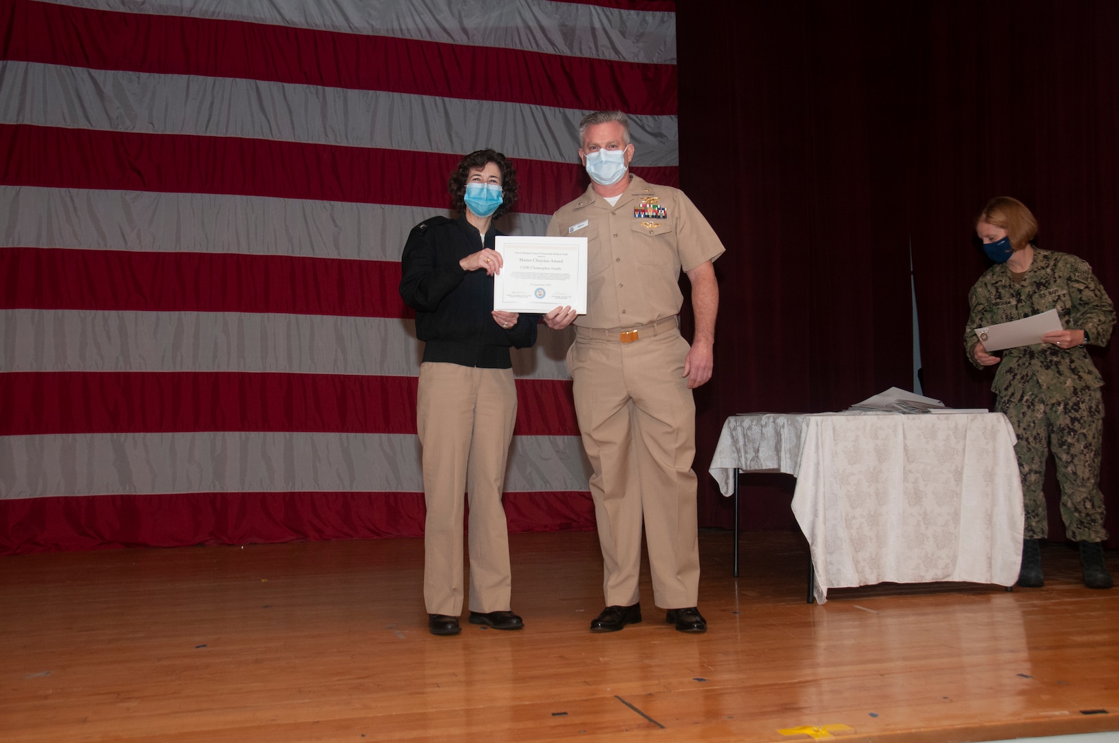 Cmdr. Christopher Smith receives a Master Clinician Award from Capt. Lisa Mulligan, Commanding Officer, NMCP at the Medical Center Nov. 10.