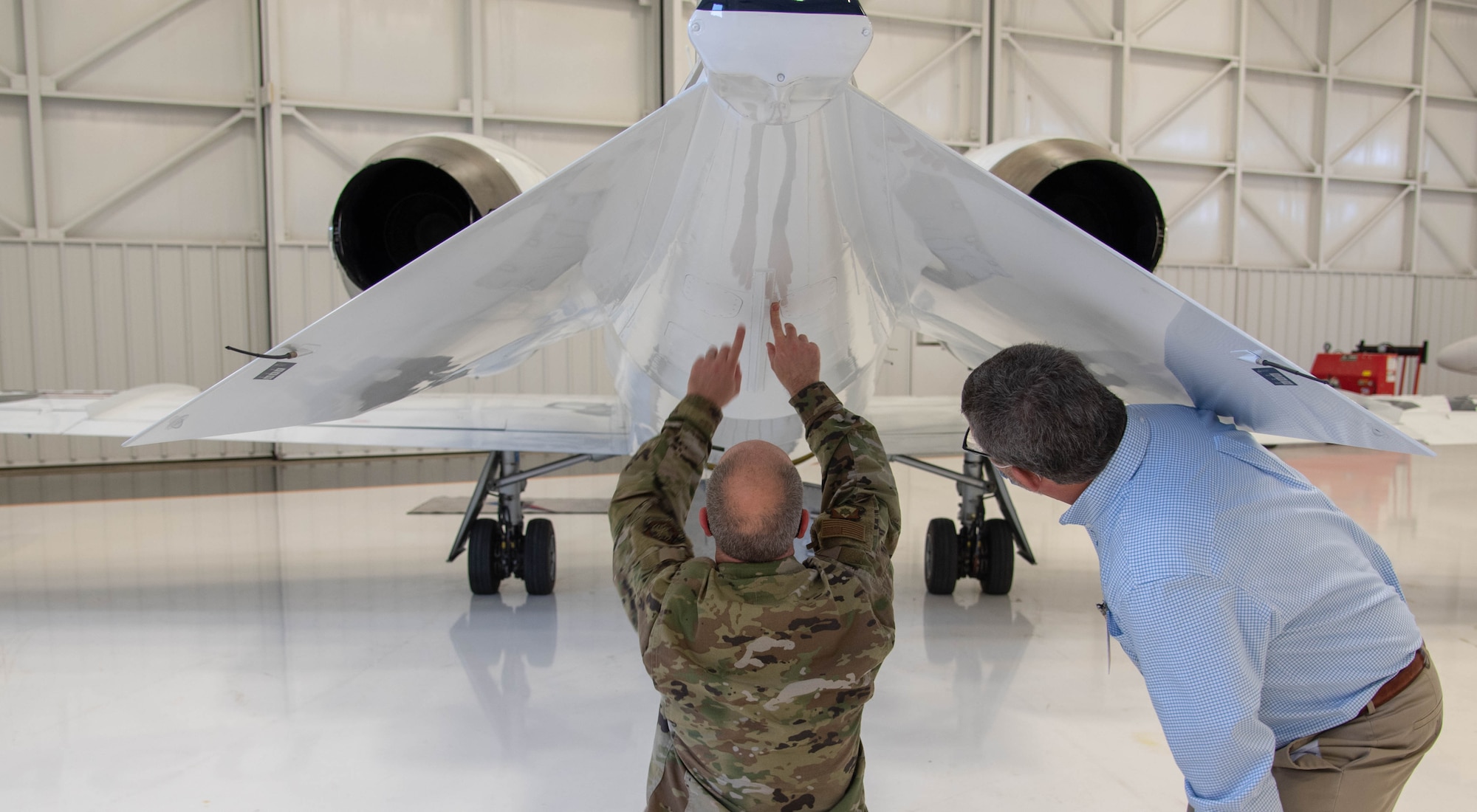 Master Sgt. Jonathon Tolbert, 375th Operations Group Contracting Officer Representative, points out the newly installed fins of the C-21A aircraft to Don Ernest C-21 Program Manager from M1 support services Nov. 10, 2020, Newton City Airport, Newton Kansas. (U.S. Air Force photo by Airman 1st Class Zachary Willis)