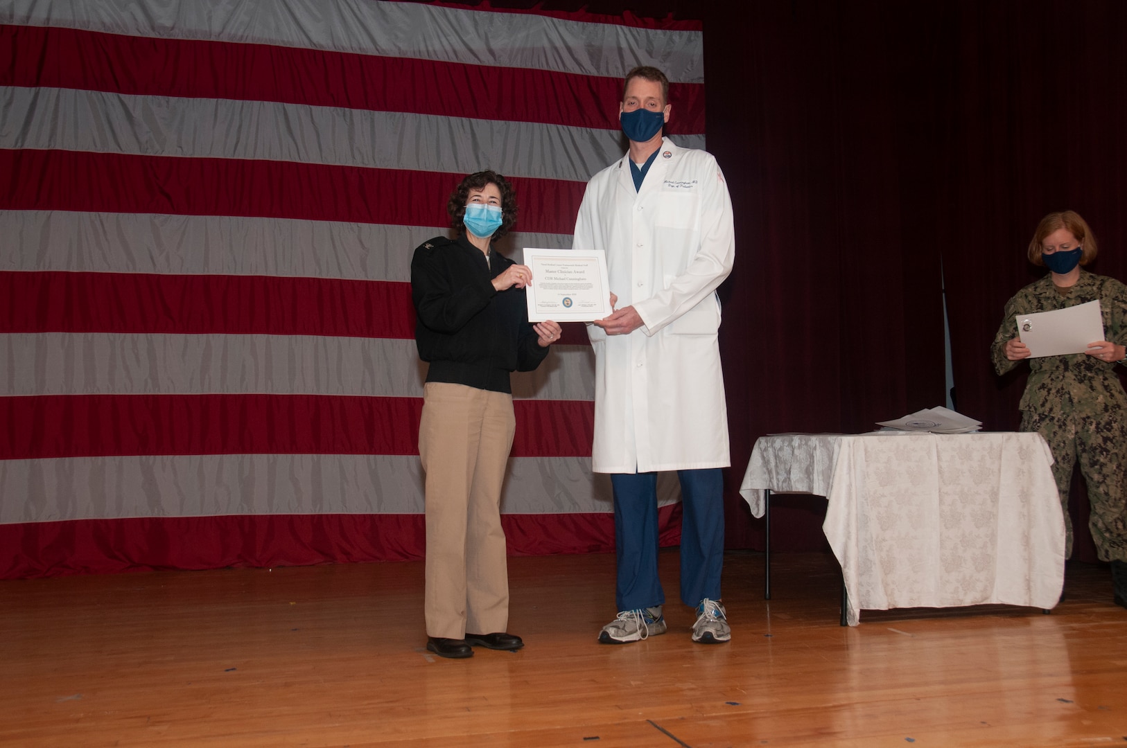 Cmdr. Michael Cunningham receives a Master Clinician Award from Capt. Lisa Mulligan, Commanding Officer, NMCP at the Medical Center Nov. 10.
